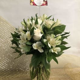 White roses and alstroemeria in a glass vase
