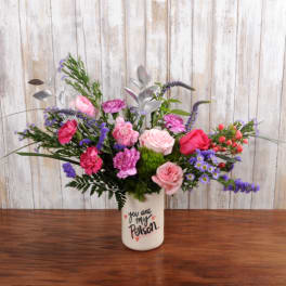 Pink roses and carnations with purple flowers in a white vase printed with 'you are my person'.