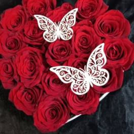 Heart-shaped bouquet of red roses with white butterfly decorations