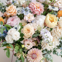 Mixed pastel bouquet with roses, dahlias, and small blue flowers