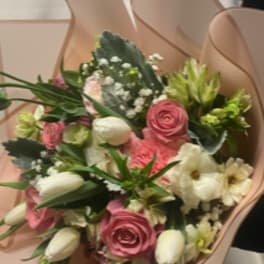 Bouquet of pink and white flowers wrapped in blush paper