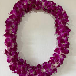 Purple orchid lei on a light background