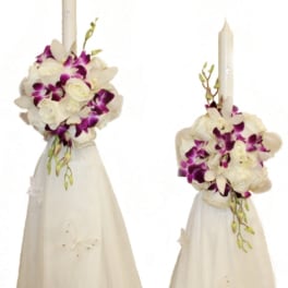 Two white floral candle arrangements with purple orchids