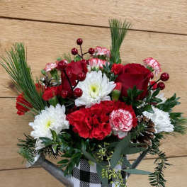 Red and white floral arrangement in a checkered metal container