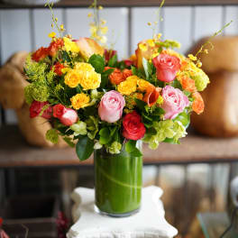 Colorful rose bouquet in a tall glass vase