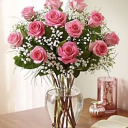 Pink roses arranged in a clear glass vase