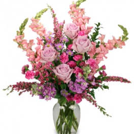 Pink and lavender flower arrangement in a glass vase