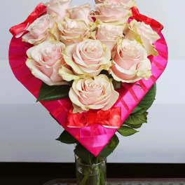 Bouquet of pale pink roses wrapped in bright pink paper