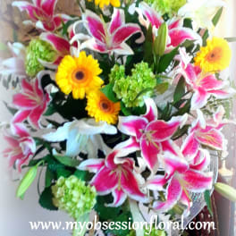 Bouquet of pink lilies, yellow gerbera daisies, and green hydrangeas