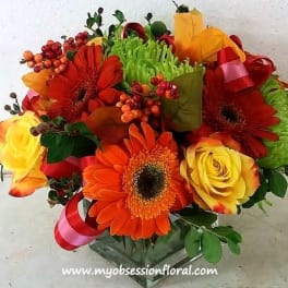 Bouquet of orange gerbera daisies and yellow roses with ribbon