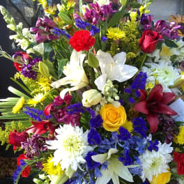 Large mixed bouquet with lilies, roses, and daisies in bright colors