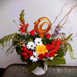 Mixed bouquet in a white vase with red, white, and yellow flowers
