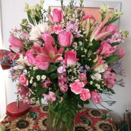 Large pink and white mixed bouquet in a clear glass vase