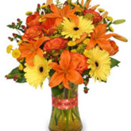 Orange and yellow mixed flower bouquet in a glass vase