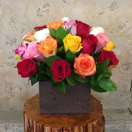 Mixed roses in a square dark vase