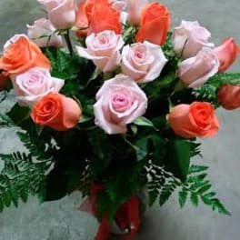 Bouquet of pink and coral roses with fern greenery