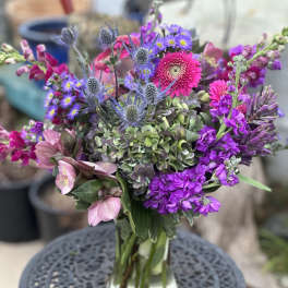 Mixed purple and pink bouquet in a glass vase