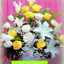 Bouquet of yellow and white roses with white lilies in a vase