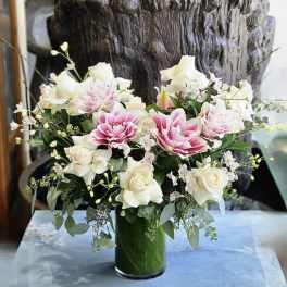 Pink and white floral arrangement in a glass vase
