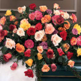 Large casket spray of multicolored roses on a dark casket