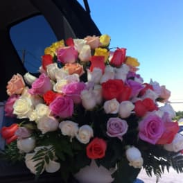 Large bouquet of multicolored roses in a white vase