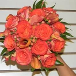 Coral rose bouquet with calla lilies and greenery