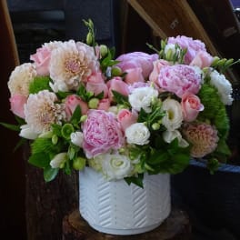 Pink and white mixed flower arrangement in a white vase