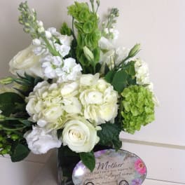 White and green floral arrangement with a Mother plaque
