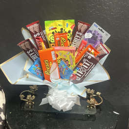 Candy bouquet with assorted chocolate bars and sweets wrapped in pale blue paper