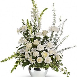 White floral arrangement in a silver vase with tall stems