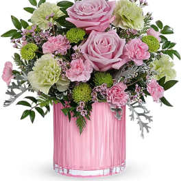 Pink roses and carnations in a pink glass vase