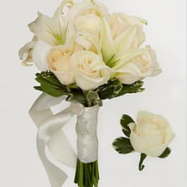 White rose and lily bouquet with a satin ribbon and matching boutonniere