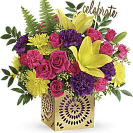 Bouquet of pink roses, yellow lilies, and purple flowers in a gold vase