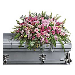 Pink floral spray on a silver casket