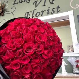 Large bouquet of red roses wrapped in black paper