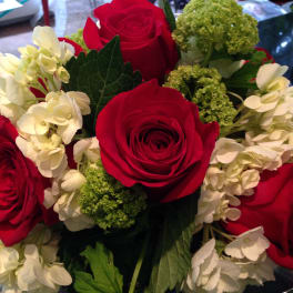 Bouquet of red roses and white hydrangeas with green accents