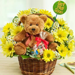 Teddy bear in a basket surrounded by yellow daisies and a "Get Well Soon" sign