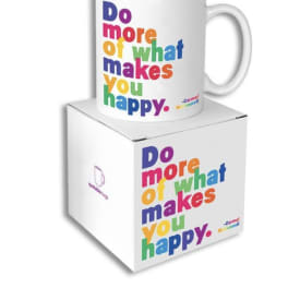 White mug and box with colorful text reading "Do more of what makes you happy."