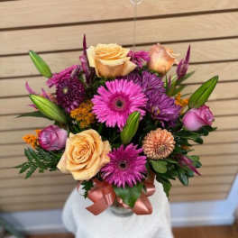 Bouquet of pink and peach flowers with a satin ribbon