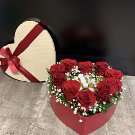 Heart-shaped box of red roses with a ribbon bow