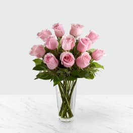 Pink roses arranged in a clear glass vase
