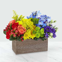 Colorful mixed flower arrangement in a rectangular wooden box