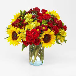 Bouquet of red and yellow flowers in a clear glass vase
