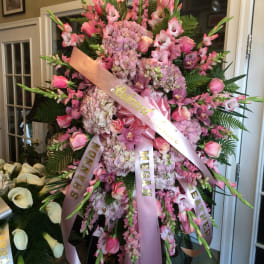 Large pink funeral spray with ribbons and orchids