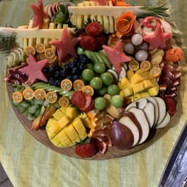 Round fruit platter with carved fruit flowers and star shapes