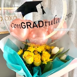 Yellow rose bouquet with a graduation balloon and pink balloons