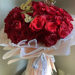Bouquet of red roses with butterfly picks and a decorative ribbon wrap
