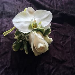 White orchid and rose corsage with ribbon