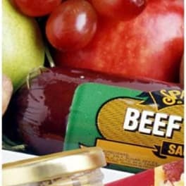 Assorted fruit and packaged beef in a gift basket