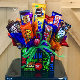 Candy bouquet in a decorated gift box with assorted chocolate bars and a green ribbon